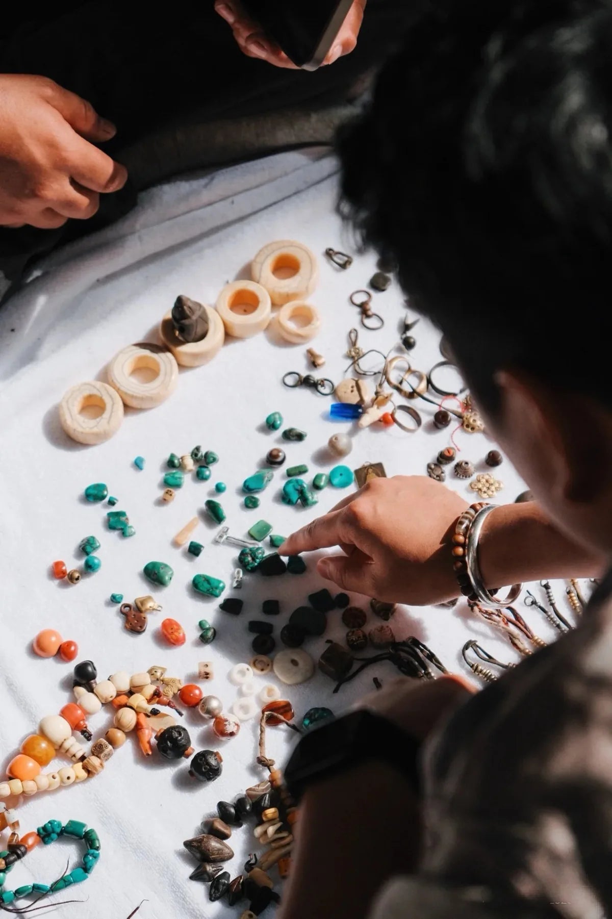Kailora artisans selecting turquoise and jewelry materials