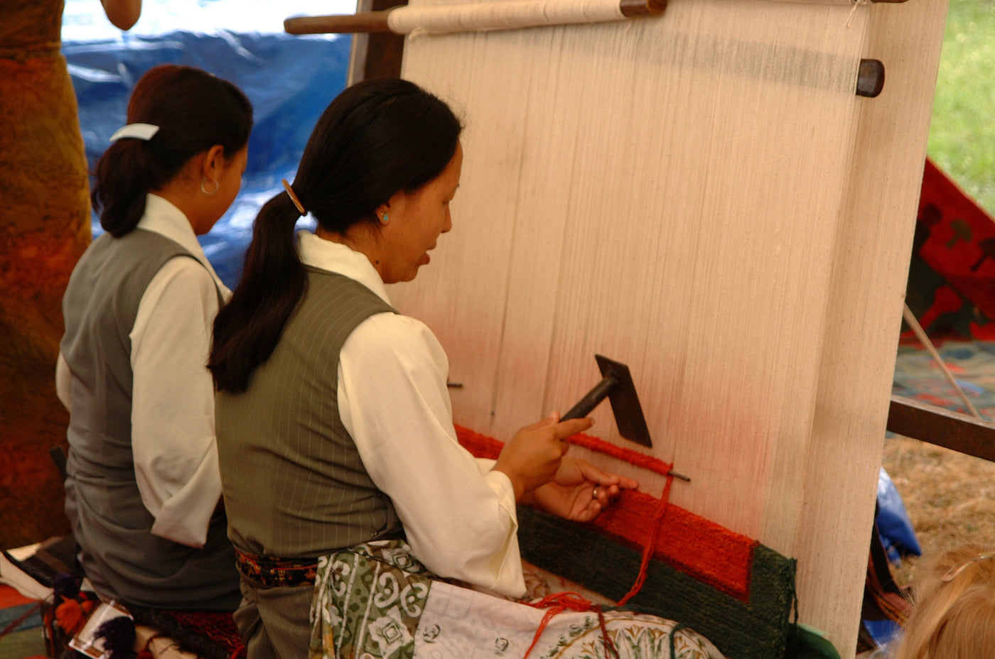 Tibetan carpet weavers from Nepal demonstrating weaving skills at the Smithsonian Folklife Festival