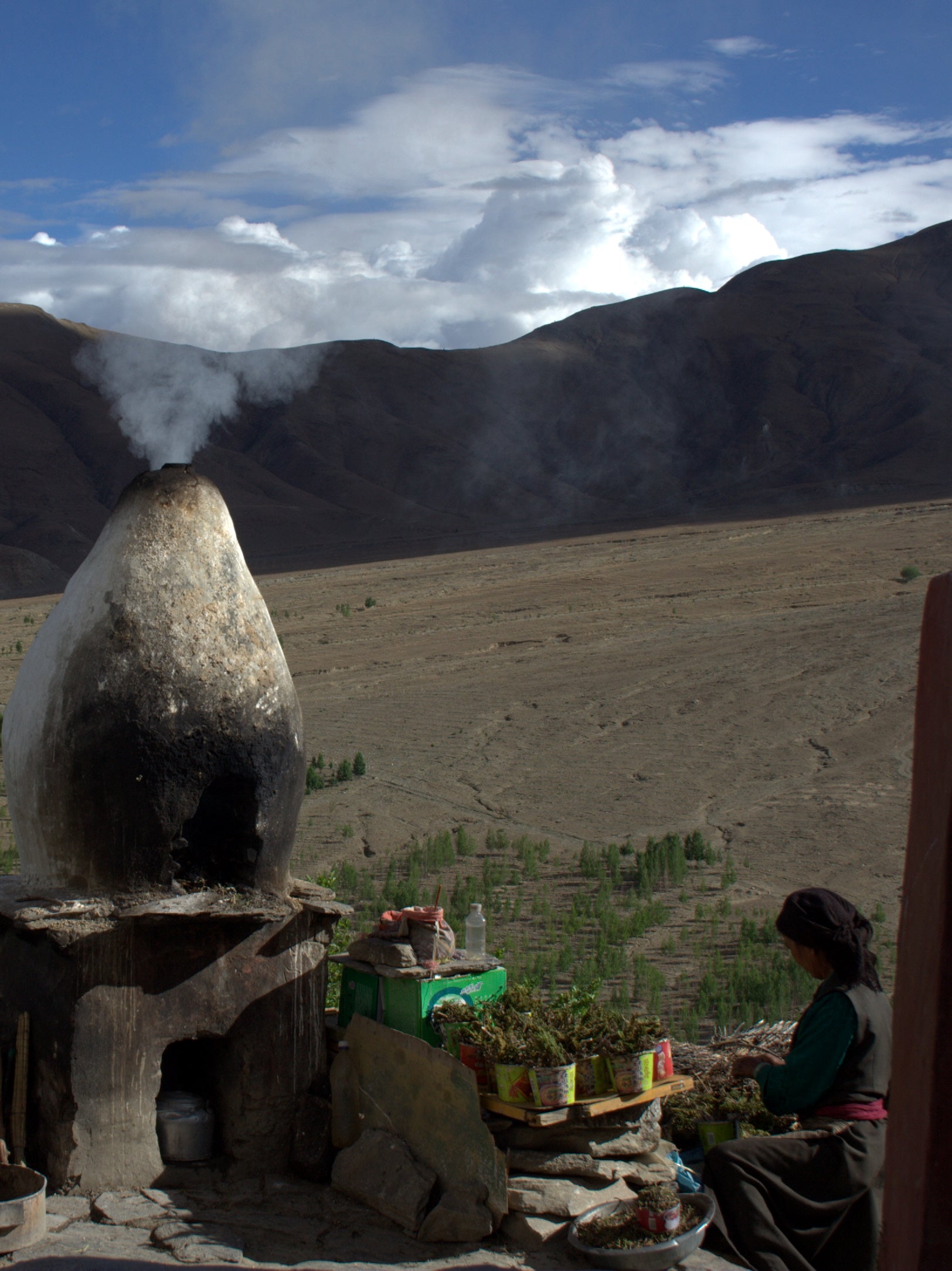 Incense burner with smoke and offerings at Yumbu Lakhang in Tibet