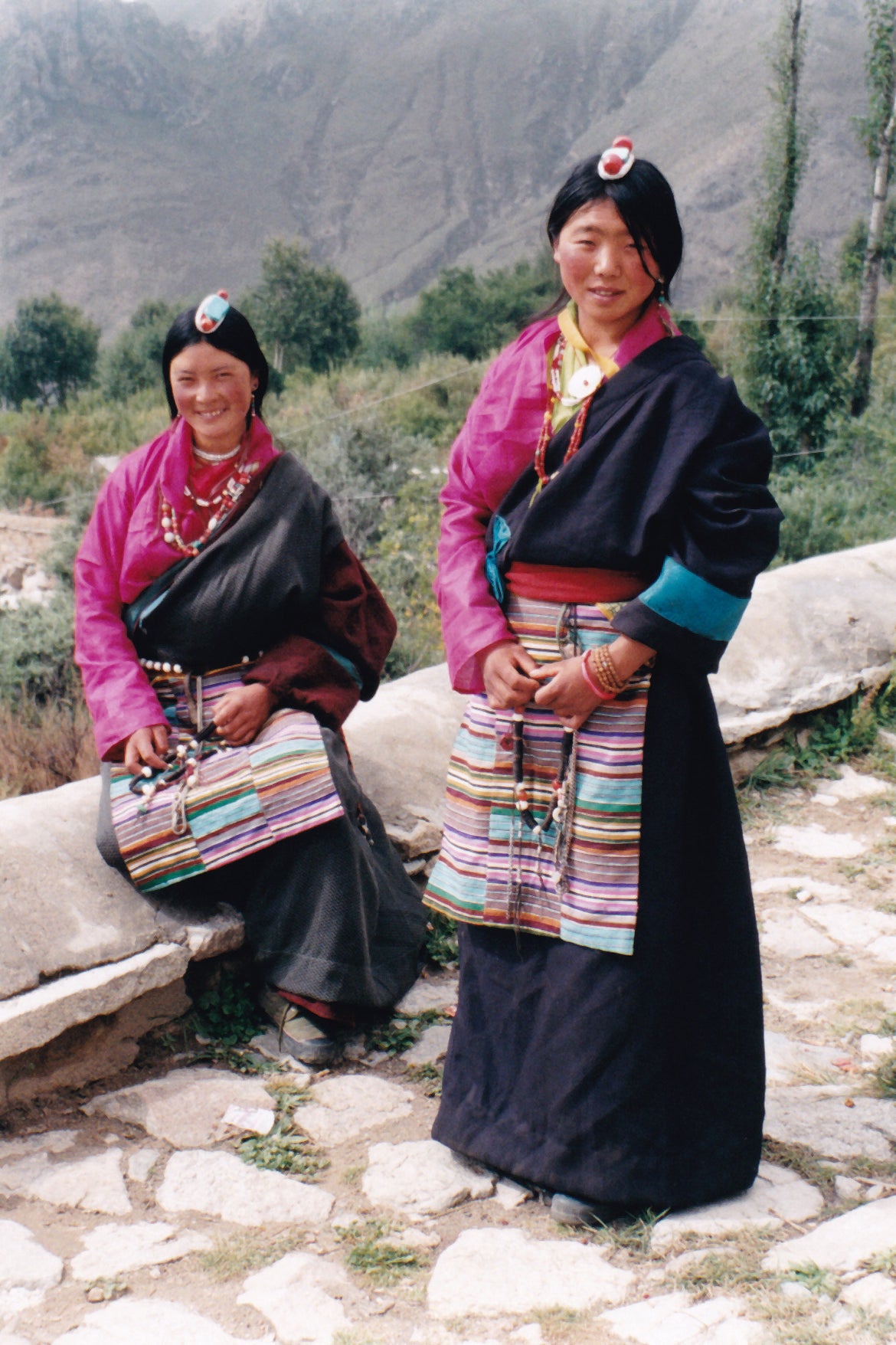 Women in Tibetan herder dress with colorful aprons near Drepung Monastery