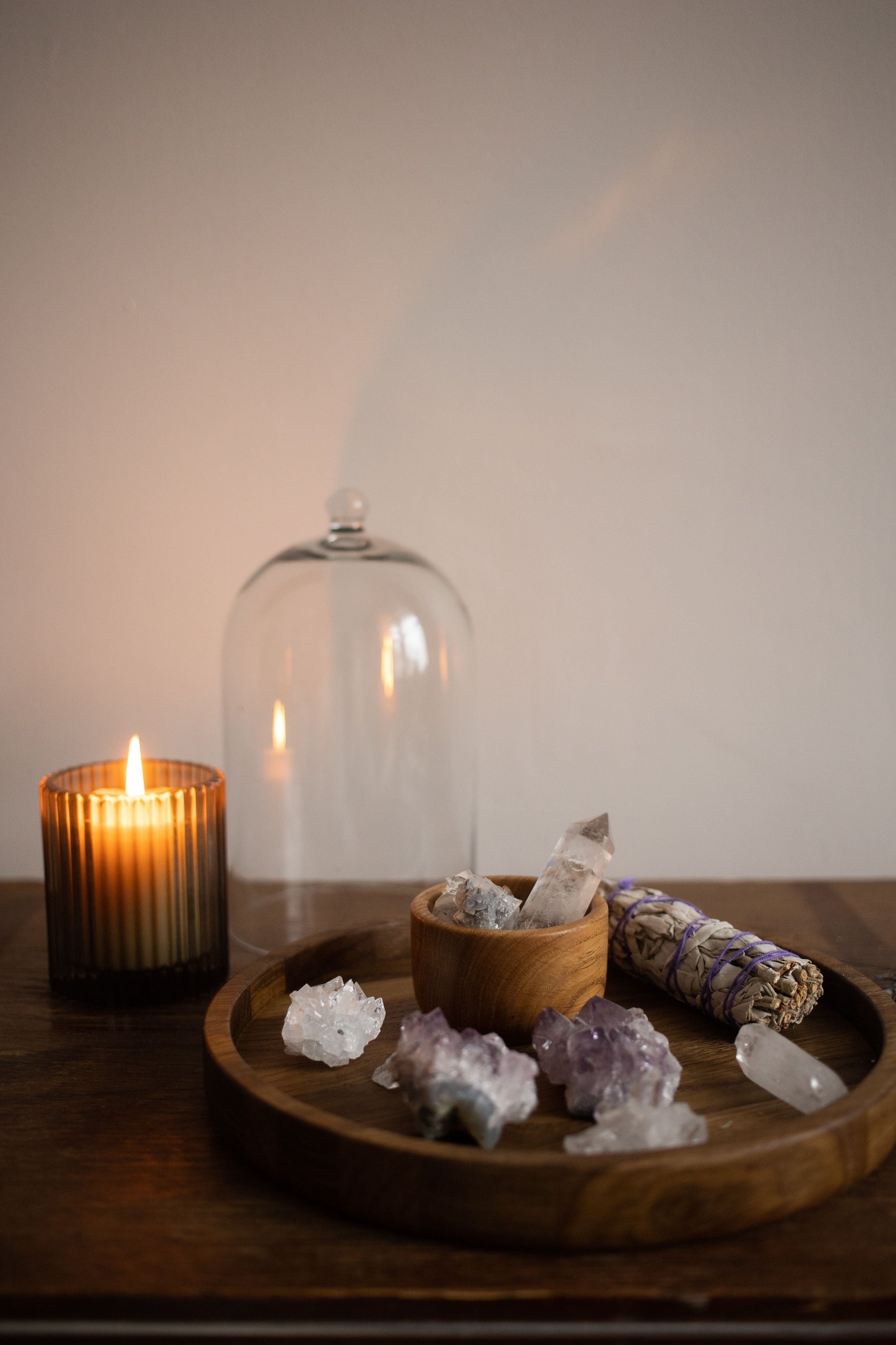 Crystals with candle and sage for a guide to safe crystal cleansing methods
