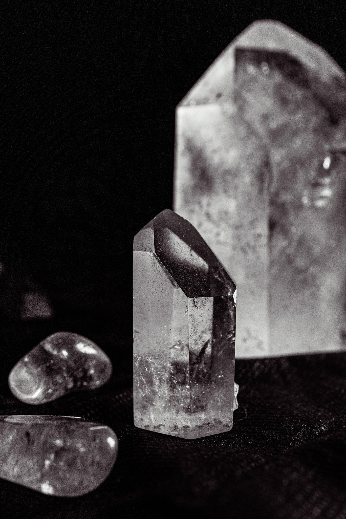 Clear quartz crystals on a dark background for an explanation of crystal energy, symbolism and mineral science