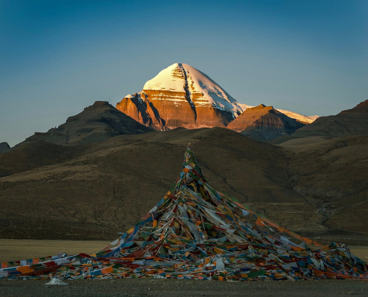 Mount Kailash at sunrise with Tibetan prayer flags, representing balance and change