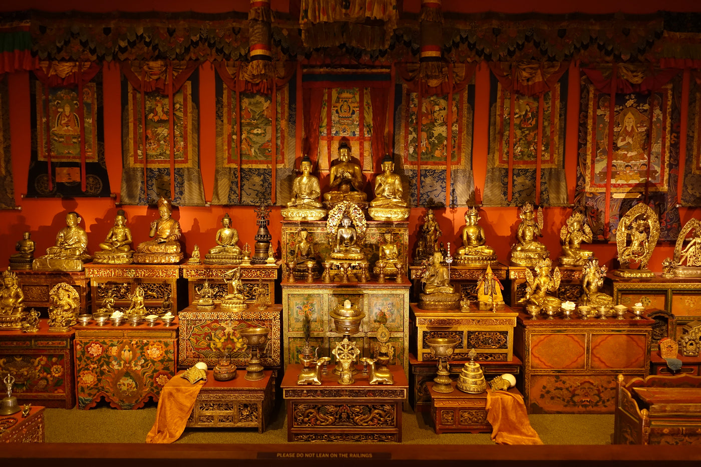 Tibetan Buddhist shrine room with sculptures, thangkas, texts and ritual objects