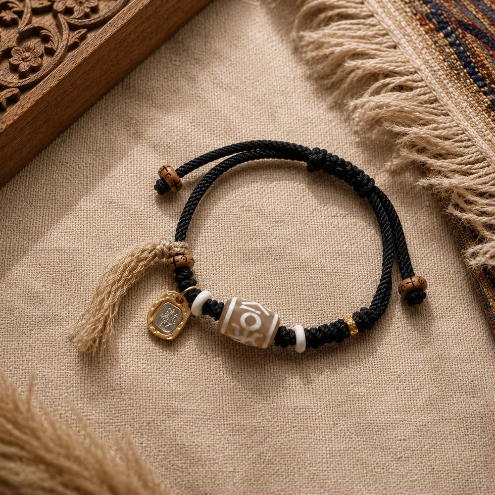 Kailora Tibetan Noble Dzi Agate Cord Bracelet with Zaki Lhamo Prosperity Charm front view | Kailora