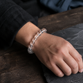 Unisex natural clear quartz bracelet worn on wrist in dark minimalist setting thumbnail 7 | Kailora