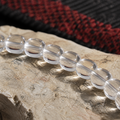 Close-up of Himalayan clear quartz beads showing transparency and hand-polished finish thumbnail 5 | Kailora