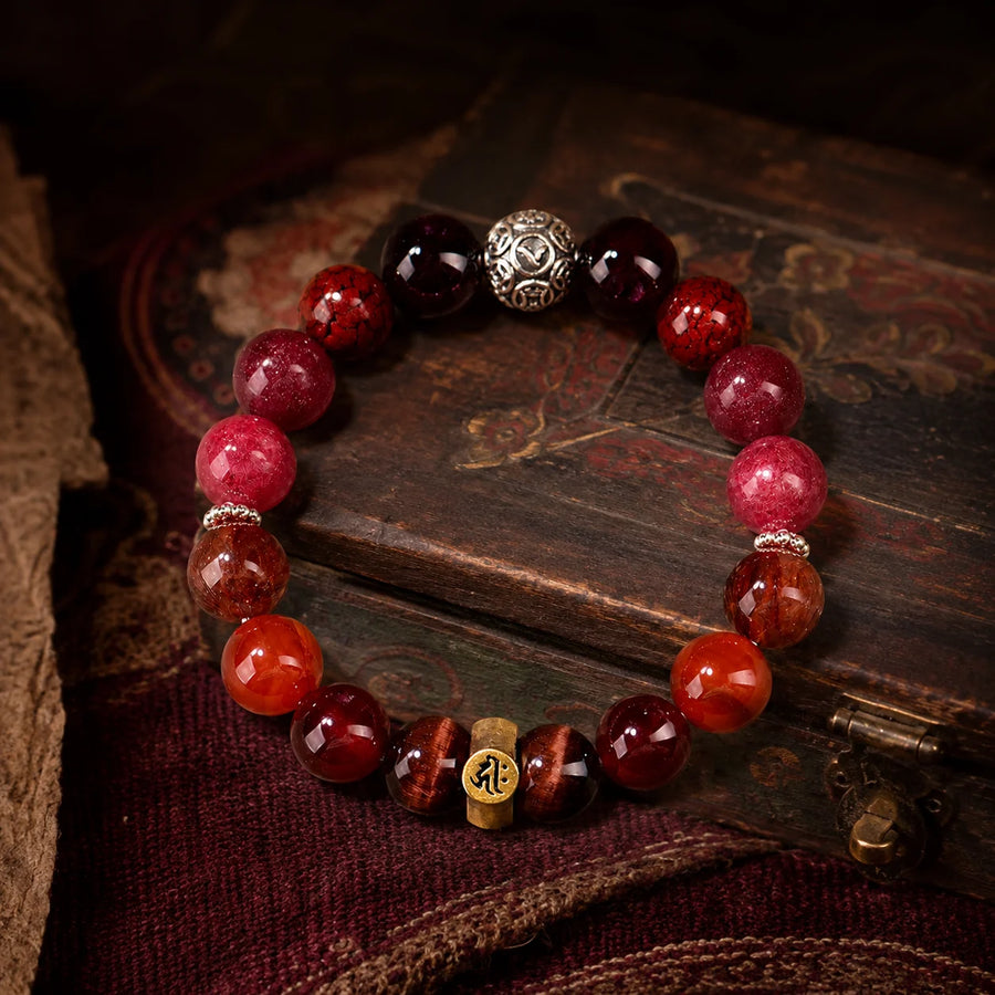 Dog and Pig Chinese zodiac crystal bracelet in a Tibetan-inspired Kailora still-life setting detail view 1 | Kailora