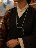 Close-up of natural agate Dzi bead on Kailora handwoven cotton cord necklace thumbnail 2 | Kailora