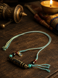 Handwoven cotton cord and natural agate Dzi bead details on Kailora necklace thumbnail 4 | Kailora