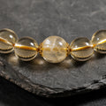 Close-up of golden rutilated quartz centerpiece on Kailora natural citrine bracelet thumbnail 4 | Kailora