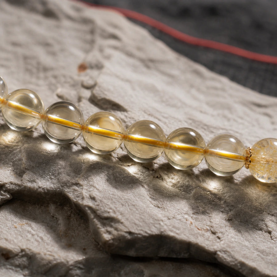 Natural citrine bracelet bead detail photographed on stone with warm golden translucency detail view 6 | Kailora