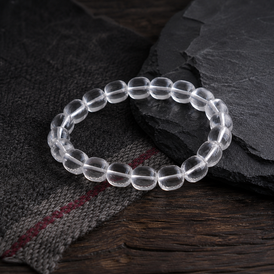 Handcrafted clear quartz bracelet displayed with Tibetan-inspired textile and dark stone detail view 8 | Kailora