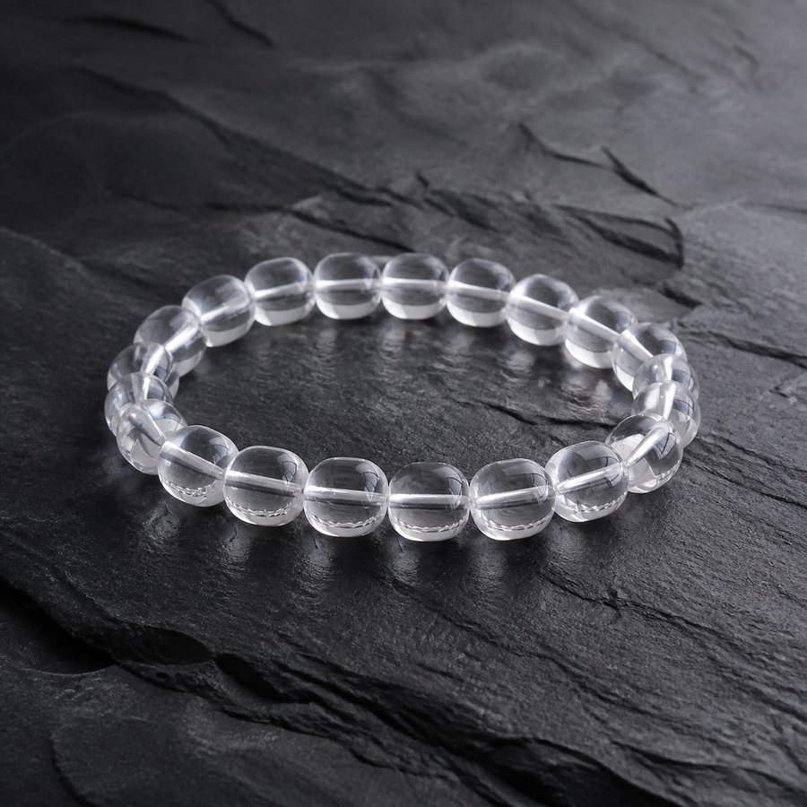 Kailora Himalayan Clarity handcrafted natural clear quartz bracelet on dark stone detail view 1 | Kailora