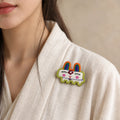 Model wearing Mao Rabbit Chinese Zodiac hand-embroidered cotton-linen brooch handcrafted in Tibet thumbnail 25 | Kailora