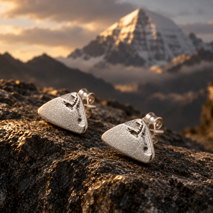 Mount Kailash-inspired silver-tone stud earrings on Himalayan rock