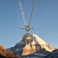 Kailora Mount Kailash necklace pendant aligned with the mountain at golden hour thumbnail 2 | Kailora