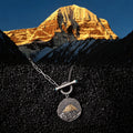 Mount Kailash pendant necklace on black rock with Mount Kailash at golden hour thumbnail 1 | Kailora
