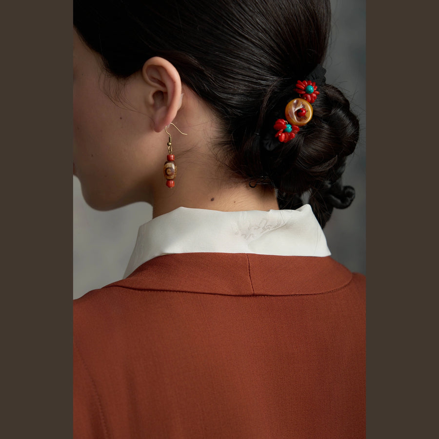 Tibetan handmade amber blossom hair clip styled around a low bun detail view 8 | Kailora