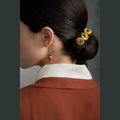 Tibetan handmade amber trio hair clip styled around a low bun thumbnail 14 | Kailora