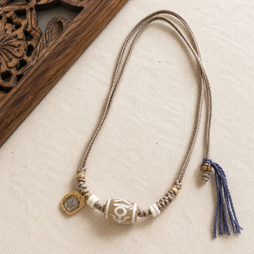 Kailora Tibetan Noble Dzi Agate Cord Necklace with Zaki Lhamo Prosperity Charm detail view 2 | Kailora