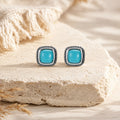Kailora turquoise stud earrings displayed on warm natural stone thumbnail 4 | Kailora