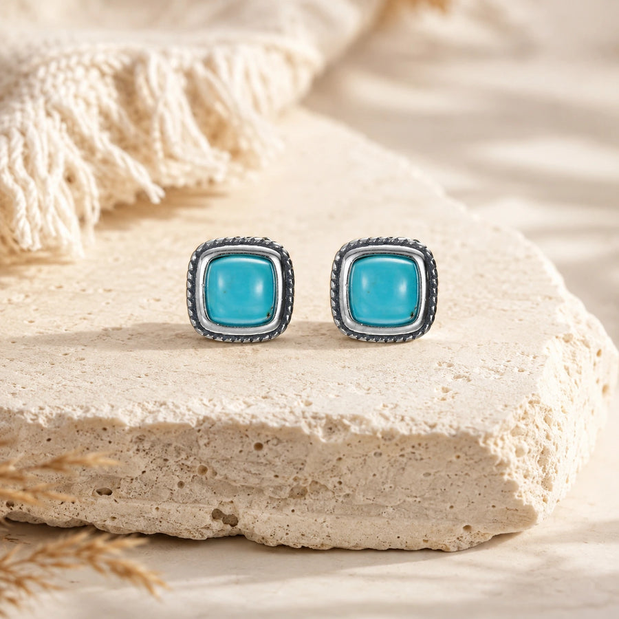 Kailora turquoise stud earrings displayed on warm natural stone detail view 4 | Kailora