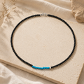 Turquoise and black agate beaded necklace styled on warm stone thumbnail 4 | Kailora