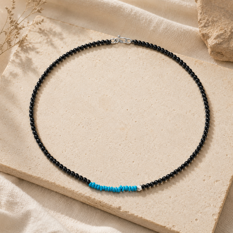 Turquoise and black agate beaded necklace styled on warm stone detail view 4 | Kailora
