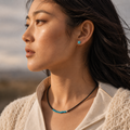 Woman wearing a turquoise and black agate beaded necklace with turquoise stud earrings thumbnail 2 | Kailora