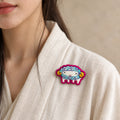 Model wearing Wei Goat Chinese Zodiac hand-embroidered cotton-linen brooch handcrafted in Tibet thumbnail 29 | Kailora