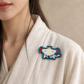 Model wearing Zi Rat Chinese Zodiac hand-embroidered cotton-linen brooch handcrafted in Tibet thumbnail 22 | Kailora