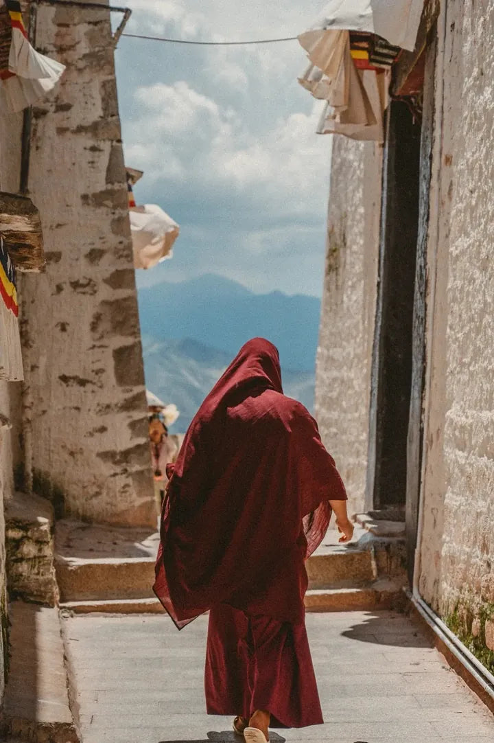 Figure walking through a traditional Himalayan passage
