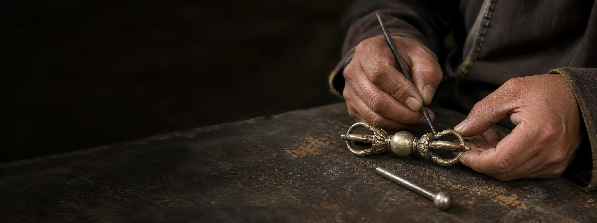 Tibetan-inspired metalworking scene finishing a Vajra-inspired jewelry form