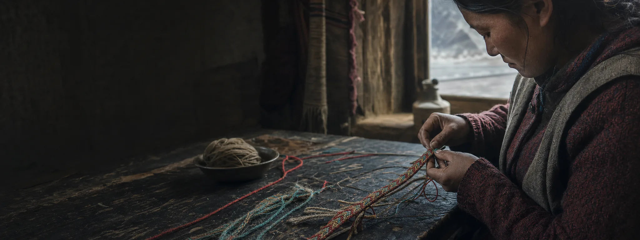 Tibetan-inspired artisan scene hand-weaving a colorful bracelet